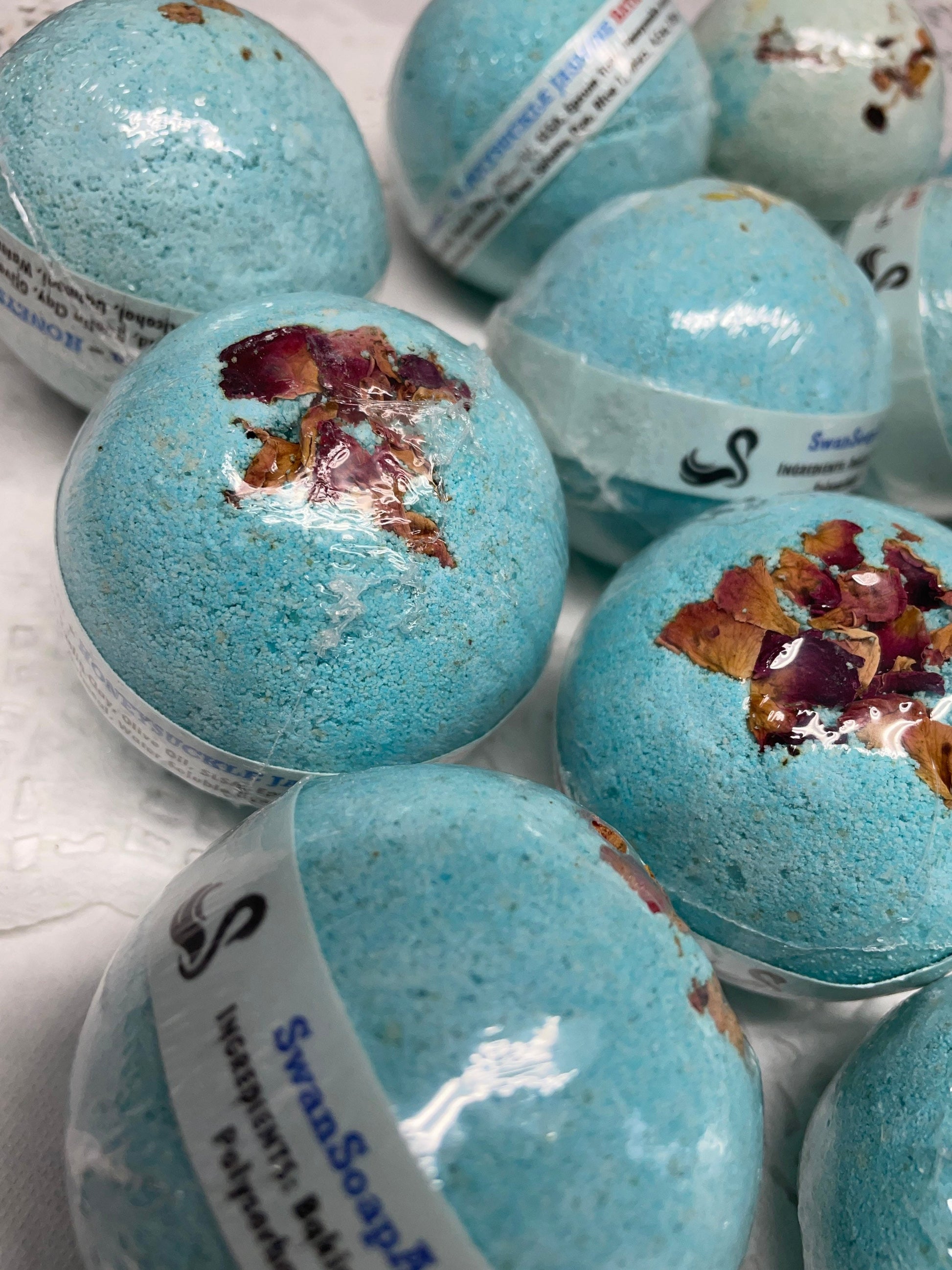a photo of Honeysuckle Jasmine Bath Bombs, with real flower petals, Rose petals or Calendula Flower Petals in a light blue color
