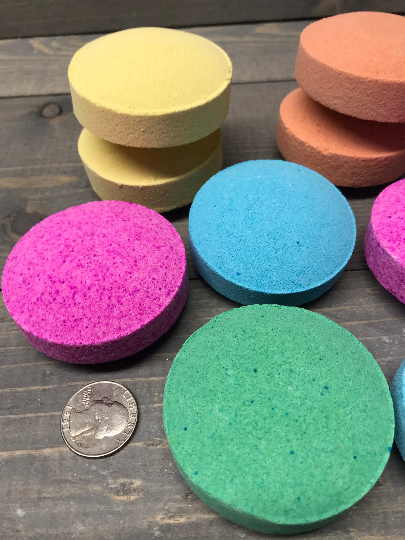 A photo showing various sizes and colors of shower steamers