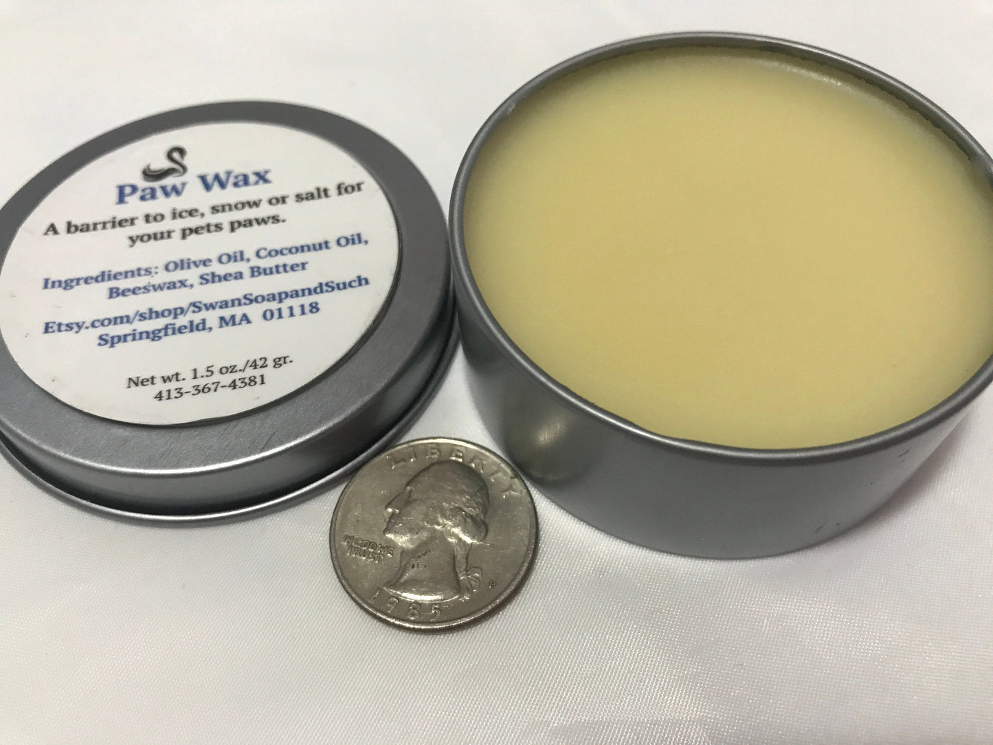A photo showing a container of Paw Wax Paw Balm