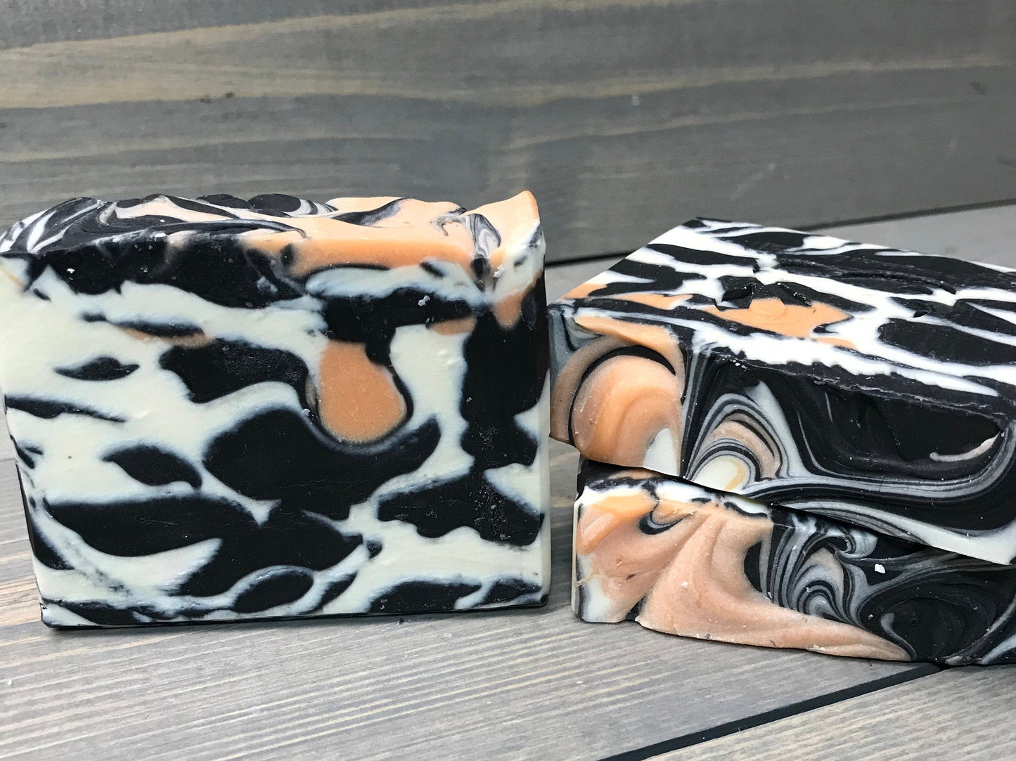 a photo of animal instinct soap with striking white and black sections with orange accents
