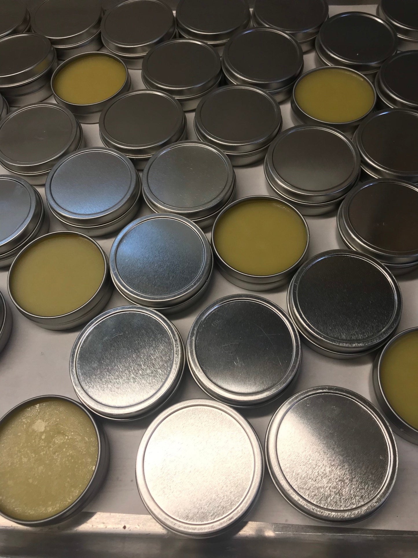 A photo showing a container of Cut and Abrasion Salve