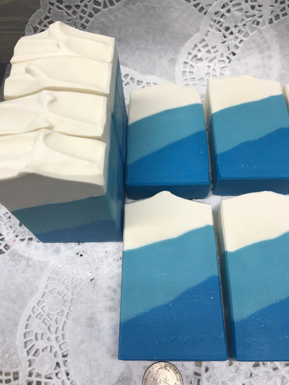 A photo of Irish Linen Soap bar soap with bands of white, light blue, and blur colors, diagonally. 