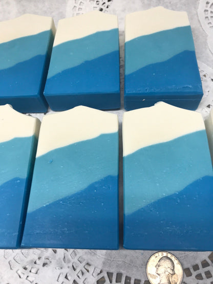 A photo of Irish Linen Soap bar soap with bands of white, light blue, and blur colors, diagonally. 