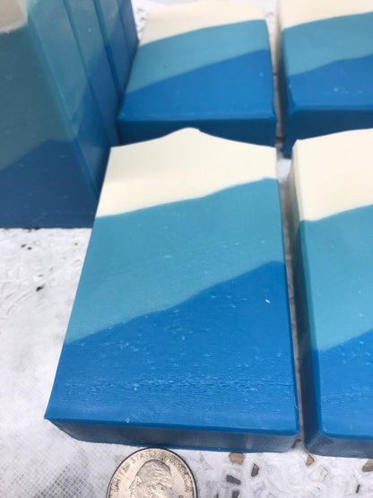 A photo of Irish Linen Soap bar soap with bands of white, light blue, and blur colors, diagonally. 