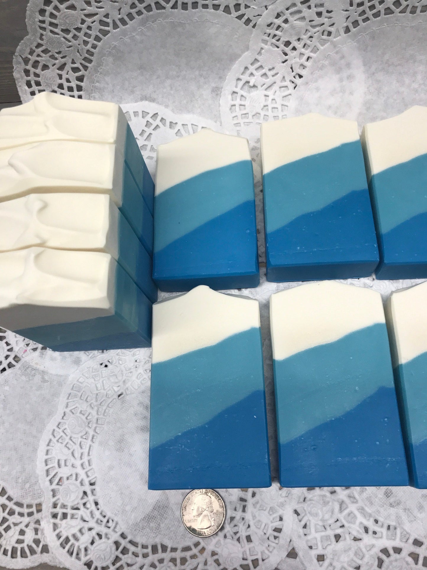A photo of Irish Linen Soap bar soap with bands of white, light blue, and blur colors, diagonally. 