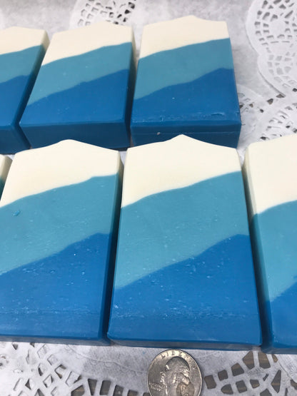 A photo of Irish Linen Soap bar soap with bands of white, light blue, and blur colors, diagonally. 