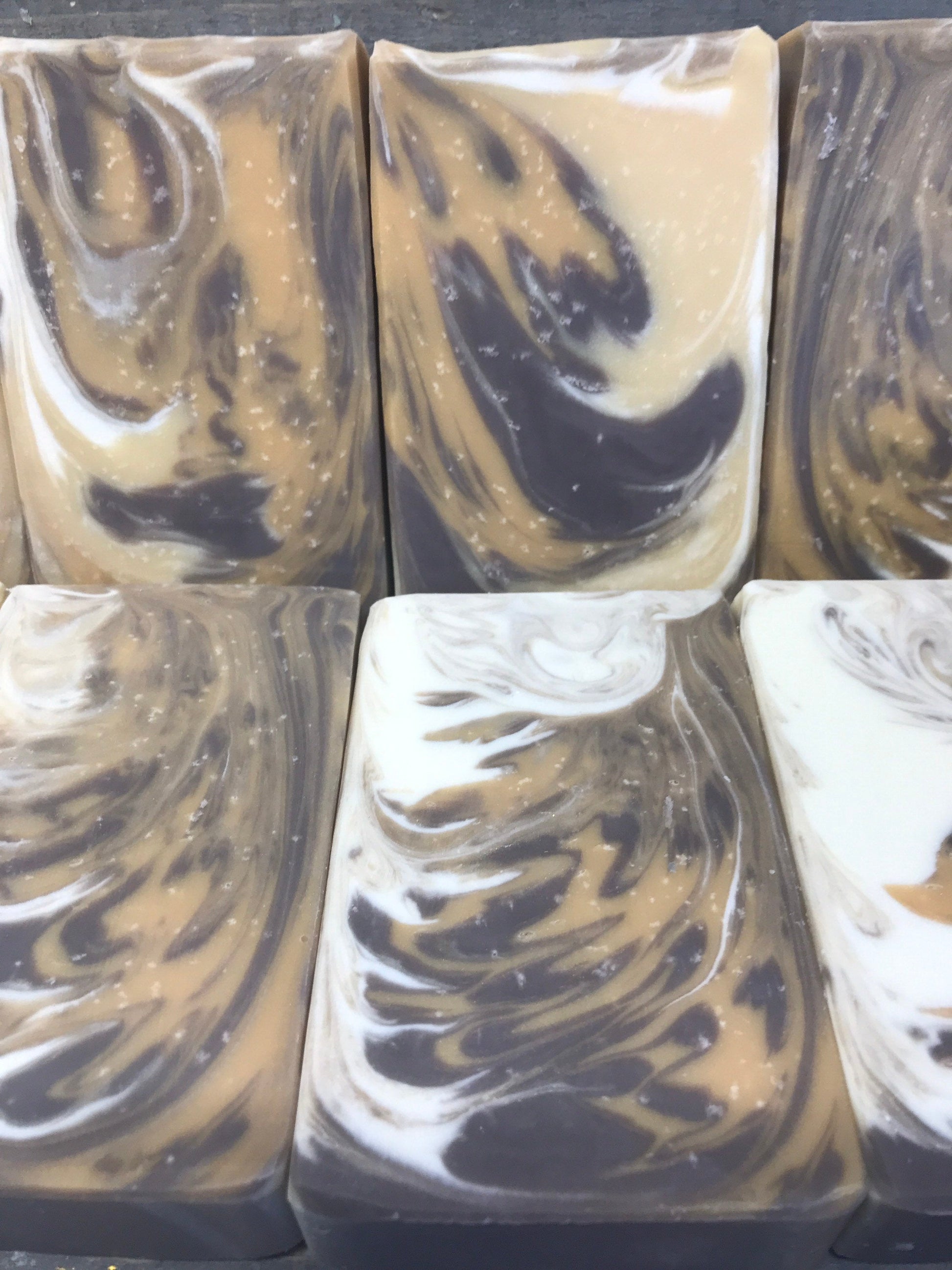 A photo showing detail of a Unscented Soap bar with browns and cream colors.
