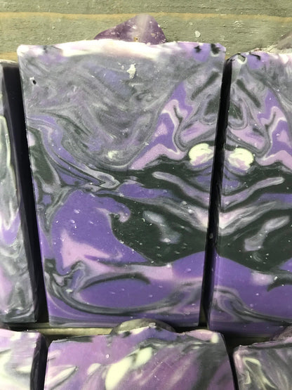 A photo of Lavender Martini with Banded Amethyst Stone on top of Bar Soap