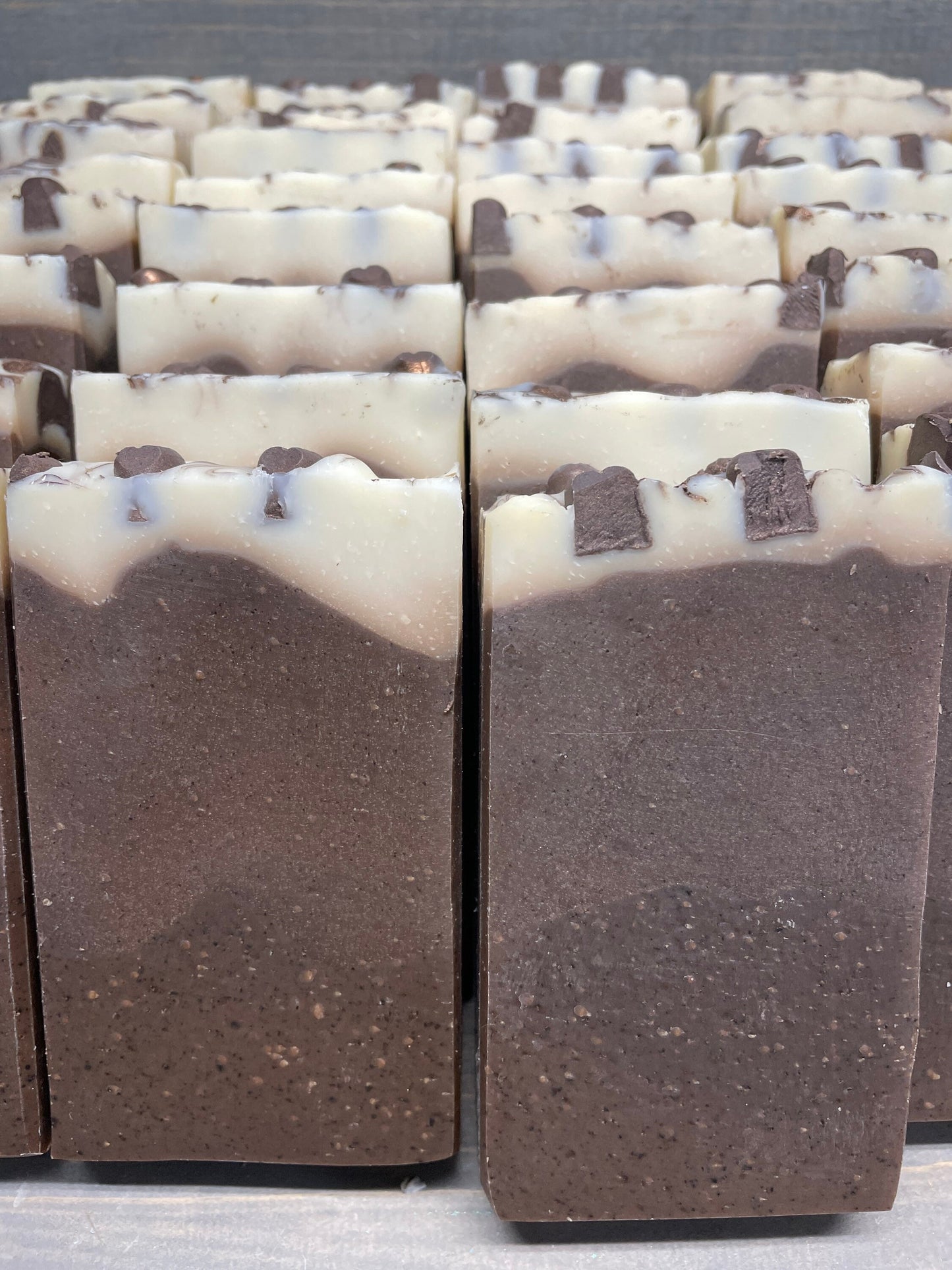 a photo of Breakfast Coffee soap, Oatmeal and Coffee Soap with a brown base, topped in a cream color and has coffee soap adornments