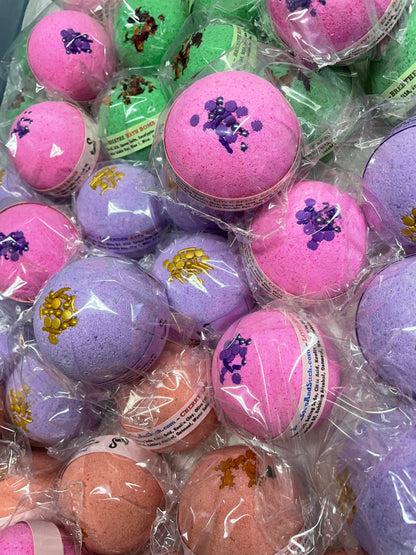 a photo of Lavender Bath Bombs with Embeds of colors topped with gold sugar sprinkles in various pastel colors