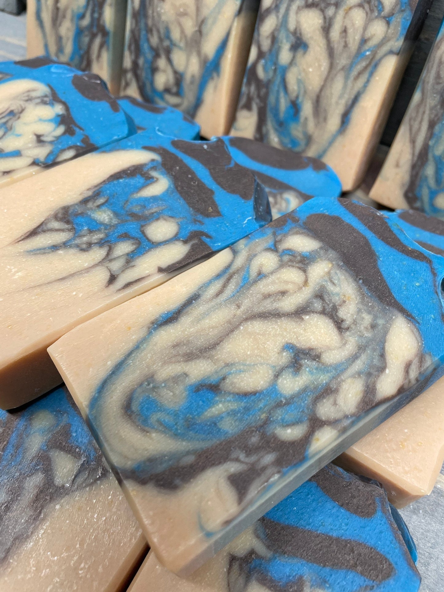 A photo of Beachwood Vetiver Goat Milk Soap with light blue and gray accent of a creamy color bar