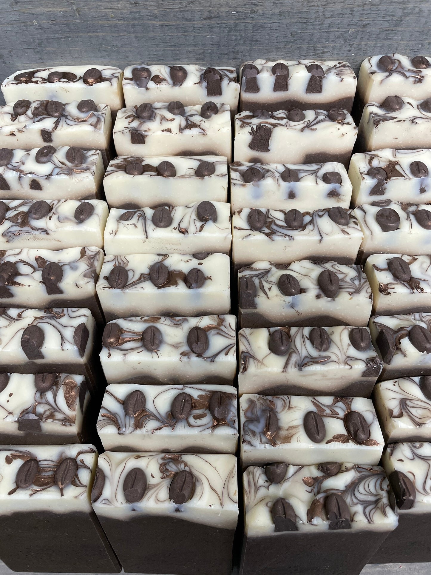 a photo of Breakfast Coffee soap, Oatmeal and Coffee Soap with a brown base, topped in a cream color and has coffee soap adornments