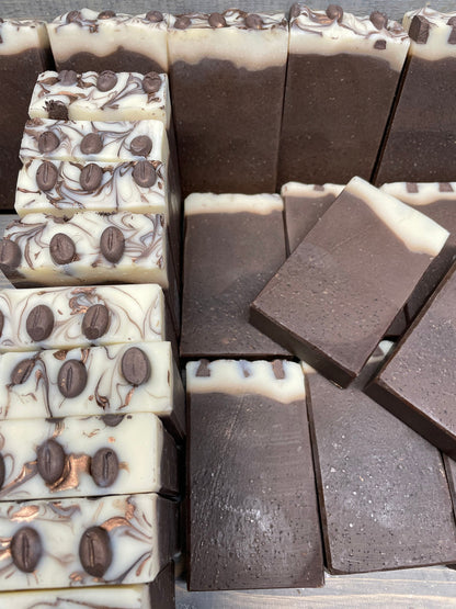 a photo of Breakfast Coffee soap, Oatmeal and Coffee Soap with a brown base, topped in a cream color and has coffee soap adornments