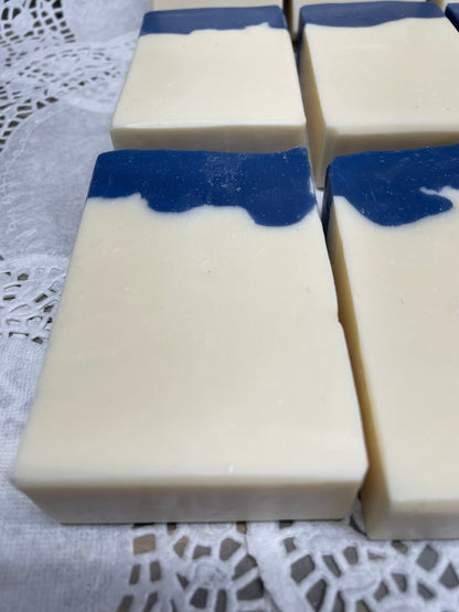 A photo of Aunt Pat’s Soap with a creamy color base, topped with a royal blue color