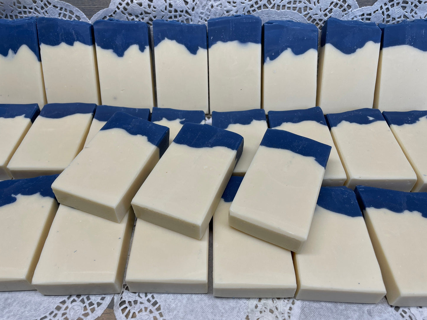 A photo of Aunt Pat’s Soap with a creamy color base, topped with a royal blue color