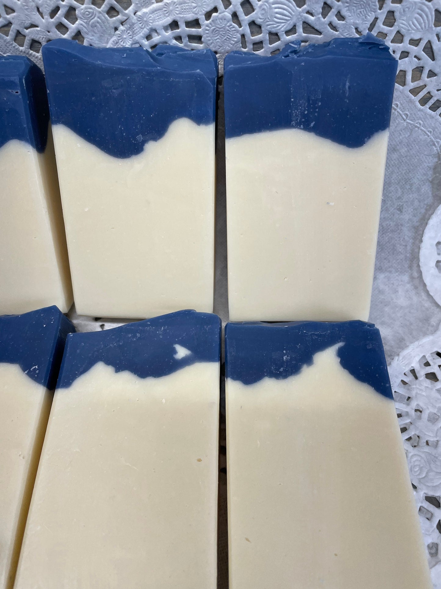 A photo of Aunt Pat’s Soap with a creamy color base, topped with a royal blue color