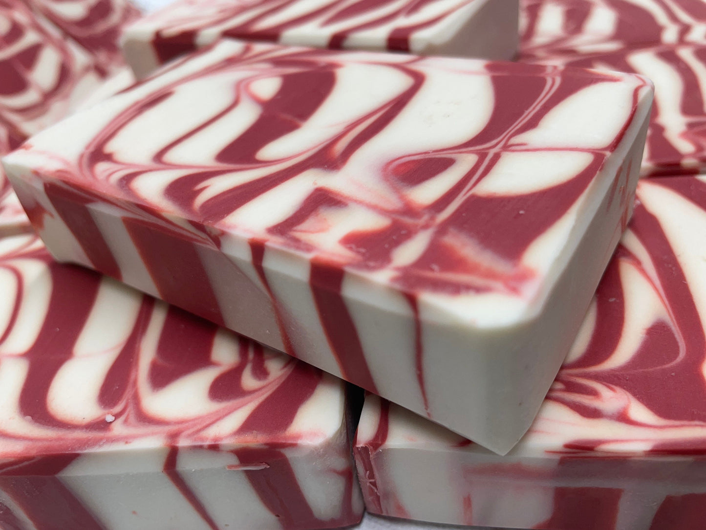 a photo of Candy Cane Soap with Peppermint Essential Oil that is striking red and white striped soap